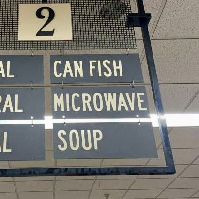 Supermarket aisle sign reading "Can Fish/Microwave/Soup"