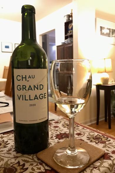Chateau Grand Village 2020, white Bordeaux,  bottle and glass in a living room settling somewhere in Ontario.
