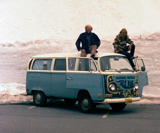 Dave Wilkins & Paul Martin on spring tour '74, sitting on Dave's VW Microbus, the Loose Blue Caboose.