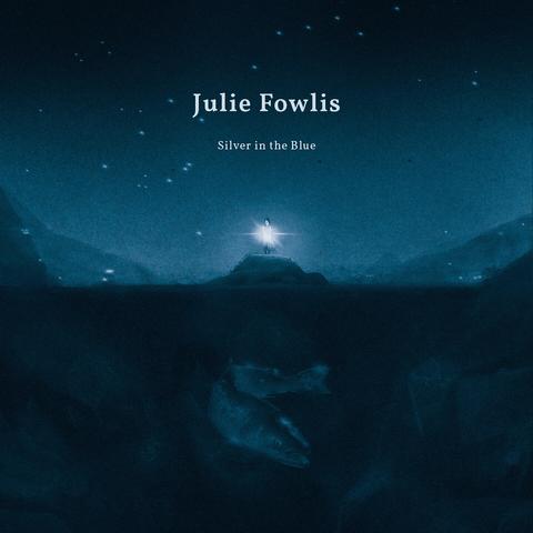 This is a piece of digital artwork and the album cover of a song called silver in the blue. It’s in shades of blue, there is a small figure in the centre of the image holding a bright white light. There is a giant fish hiding in the depths of the water below.