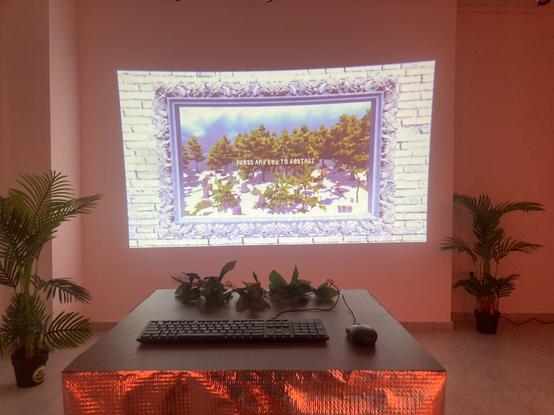 Keyboard Landscaper, a musical and visual toy made by Tatiana Vilela dos Santos and Olivier Drouet, exhibited in Belgrade, Serbia as part of an A MAZE. Pop up exhibit. In this game, your keyboard turns into a tone matrix: an electronic musical instrument inspired by Japanese artists Toshio Iwai and Yu Nishibori's Tenori-on. 
The picture shows a keyboard and a mouse on a silver table and a huge video projection on a wall featuring a painting's frame with a winter landscape.