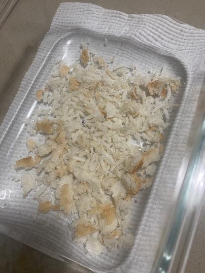 Delicious bread and rice for a lost quail. White bread and rice crumbled up together.