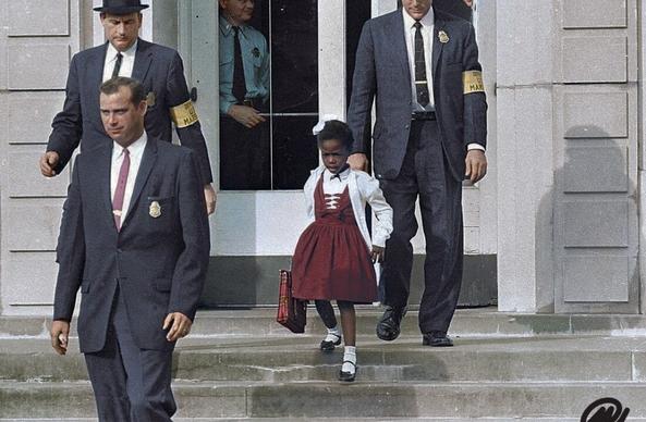 Ruby Bridges at 6, being escorted to school by US Marshals