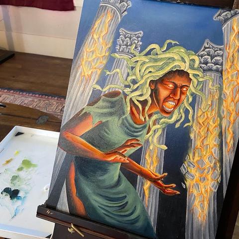Painting in progress on an easel with a palette of paint beside it. Painting shows snake-haired Medusa in a torn green dress, screaming, surrounded by Greek columns that are exploding into fire.