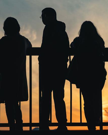 3 people outlines watching the sunset