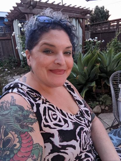 Bela is sitting in a small, fenced-in garden in San Diego.