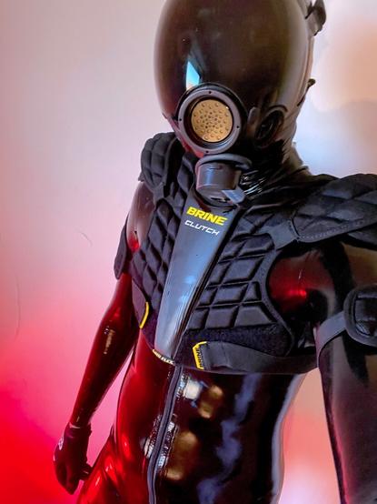 The rubber-clad drone in a domed respirator and a lacrosse chest protector silently assesses the best way to assimilate you into the collective