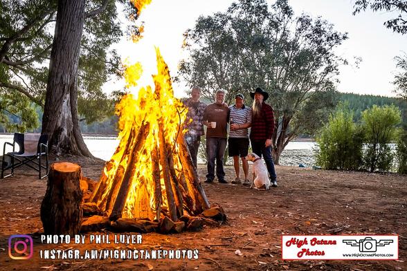 Blokes standing by a fire