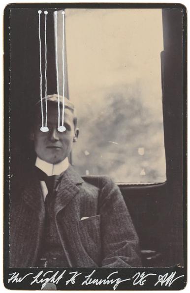 Black and white photograph of a man on a train, facing the camera. Photo altered with white paint over eyes, and streaks of “light” traveling up and away.