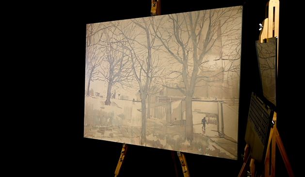 This photo shows an image of a cityscape painting. The view is of St Mary's church, here in Sheffield as seen from inside the nearby roundabout. The picture shows a church with a glow where the clock face should be. Silhouettes of trees fill the scene and a bank of grass leads up to the side of the road. A small man can be seen walking into an entrance to an underpass. This layer shown is an underpainting layer so all the forms are feint a pale beige wash covers the image suggesting foggy nighttime.