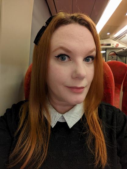 A selfie of my face while sitting on a train.