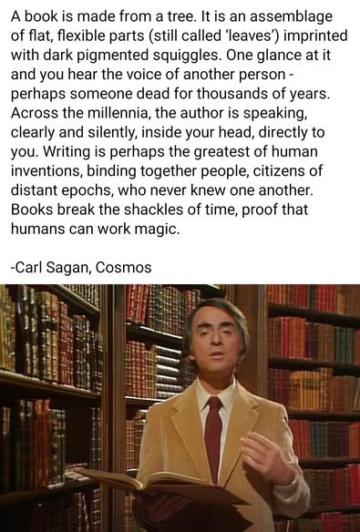 Carl Sagan in library holding a book saying how books are magic, reading thoughts of another.