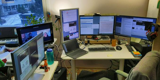 Picture of a messy desk with a lot of computer equipment on it.
