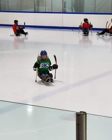 Me at sledge hockey practice, pushing myself across the ice.