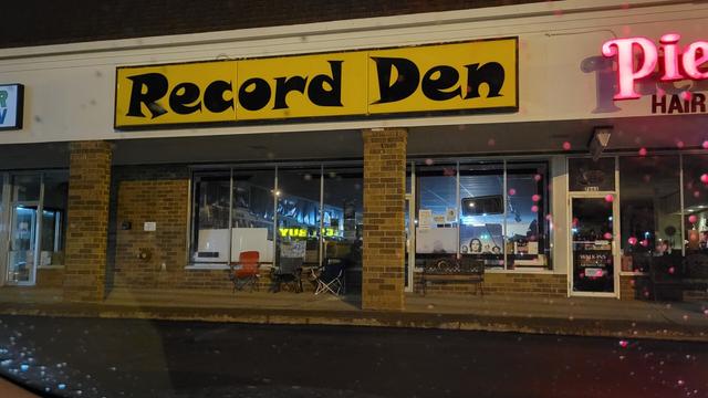 My red chair outside The Record Den in Mentor, OH! Third in line, yay!