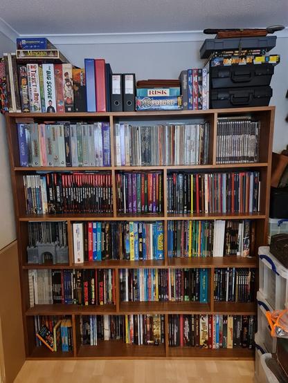 A 6 foot by 6 foot bookcase full of roleplaying books (5 shelves in total). The top is full of board games and miniatures cases.