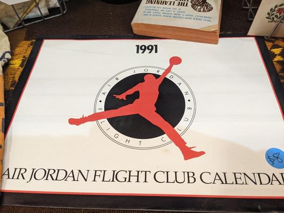 1991 Air Jordan Flight Club Calendar with a black and red logo of Michael Jordan's signature leap