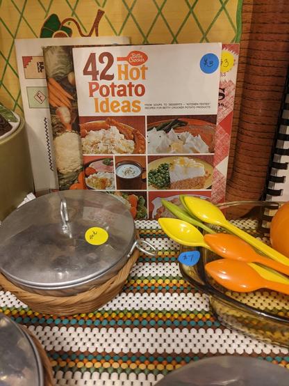 42 Hot Potato Ideas, a vintage cookbook, flanked by 1960s style dinnerware
