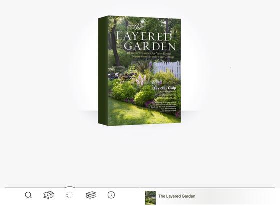 The interface of LibbyApp on an iPad while opening a new book. In this case, the book is The Layered Garden by David L. Culp, and features a picture of a manicured garden with tightly trimmed green lawn, full flower borders, a white picket fence, and wild-bordering-on-forest beyond.