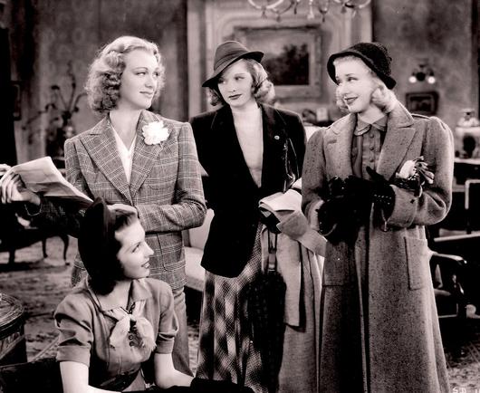 Four women in a living room.  Miller, seated at left. Arden, Ball and Rogers standing immediately behind. Rogers wears an overcoat.