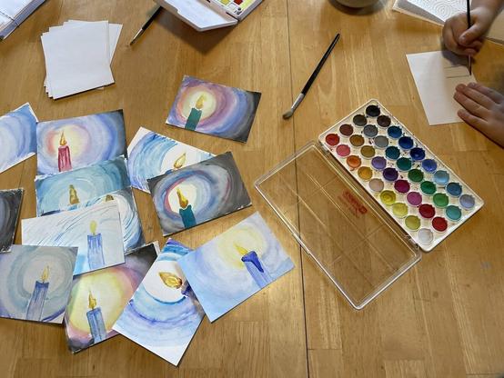 Our daughter making water colour Chanukah and Christmas cards - each one a candle to give hope