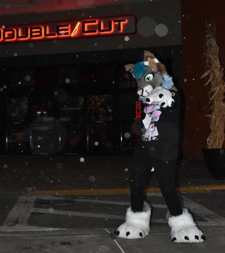 Picture of Kasia pointing at the camera outside a fancy restaurant