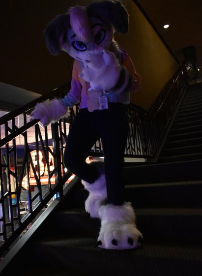 Candy walking downstairs holding her nose