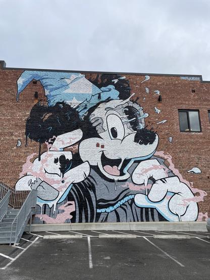 A large mural on a brick building of Mickey Mouse as the Sorcerer’s Apprentice, and he appears to be beginning to melt or disintegrate.