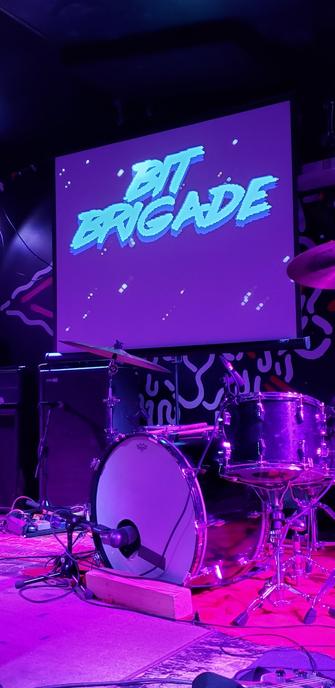 The pre-show screen for the band Bit Brigade.