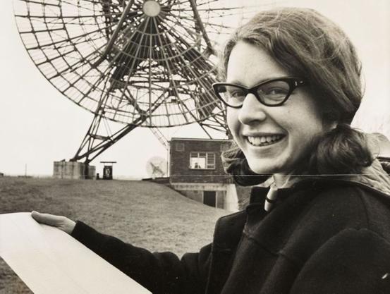 Jocelyn Bell Burnell in the 1960s, in front of a radio telescope