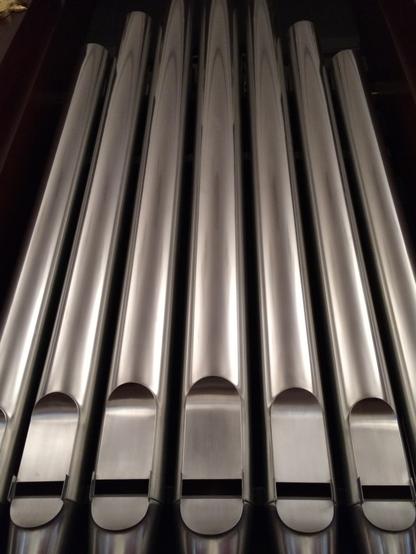 Silver shiny organ pipes extending upward