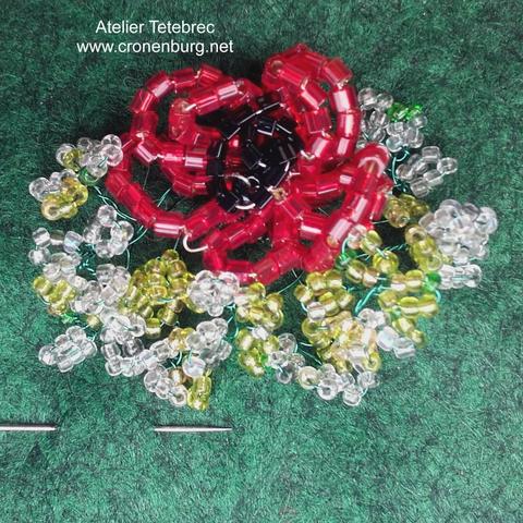 poppy flower in French perlage technique made with very tiny glass beads.