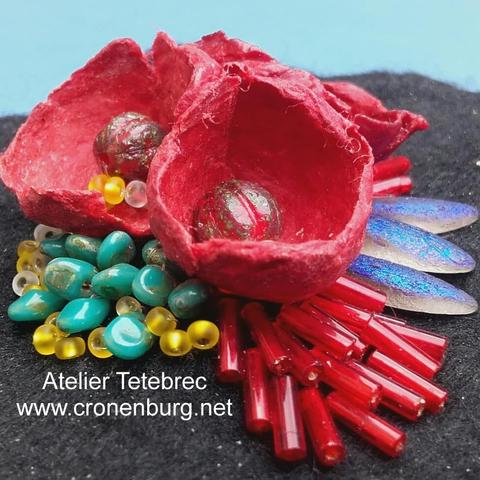 Perlage work for a brooch: red flowers made with hand-felted Japanese mulberry paper. Embroidered glass art beads.