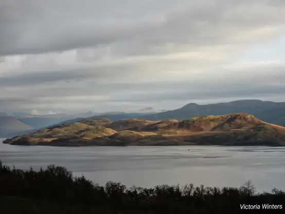 A view down to Loch Fyne showing the light highlighting the hills and mountains in the distance
