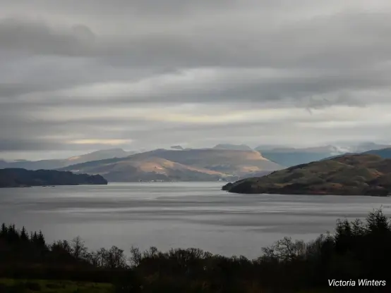A view down to Loch Fyne showing the light highlighting the hills and mountains in the distance