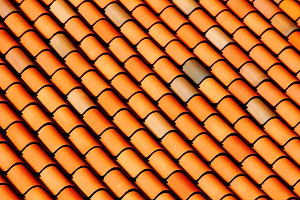 Weather resistant terracotta clay tiles in brownish orange on the hotel roof on the island of Hispaniola in the Dominican Republic make a lovely abstract. The curved design in brownish orange create a super light and shadow pattern. Also great in black and white!
