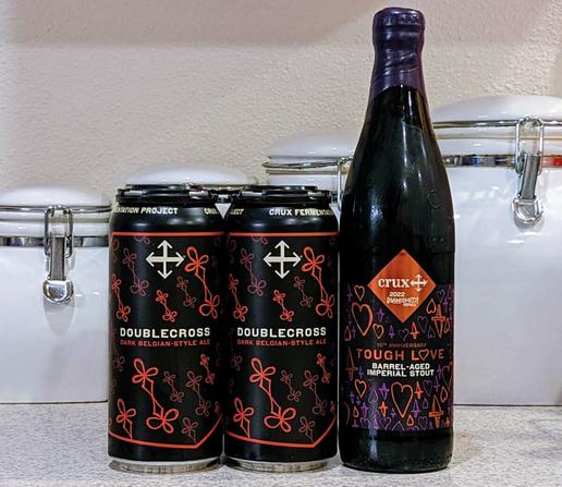 Cans of Crux Fermentation Project Doublecross Belgian Dark Strong Ale and a bottle of Tough Love Imperial Stout