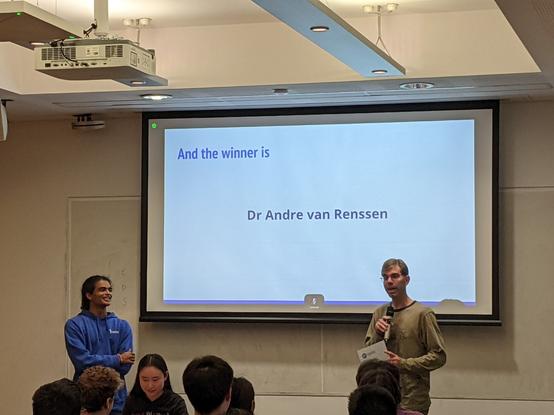 Photo of André receiving the certificate, awarded by our computer science students.