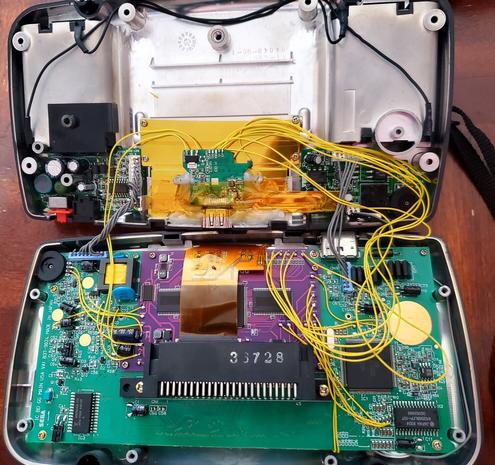 The complex internal wiring from the new driver board tying in the audio to the HDMI connector