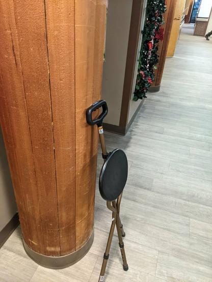 Cane stool leaning against a pillar in a hallway