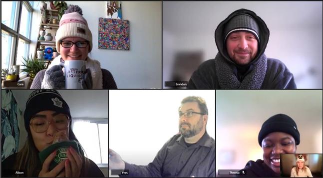 A group of people wearing hats and winter gear indoors