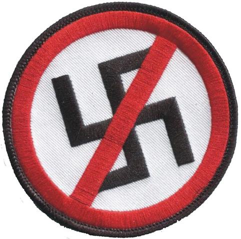 A cloth patch depicting a swastika being crosses out by a red slash