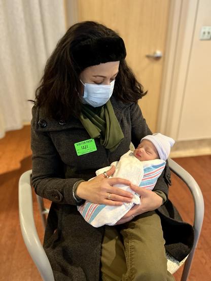 My beautiful wife holding our brand new grandson.