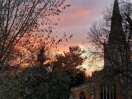Red sunset sky and village church photo taken by Linda Sgoluppi 3 December 2022
