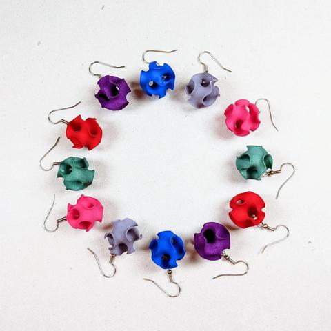 Ten Gyroid Earrings of various colors, viewed from above.