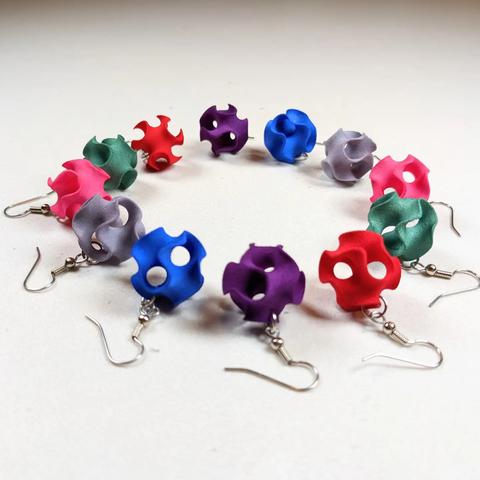 Ten colorful Gyroid Earrings arranged in a circle, viewed from the side