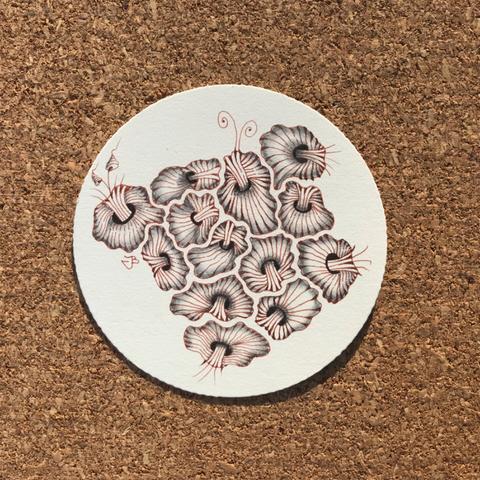 A round Zendala tile with amoeba like features in the centre drawn in brown-red ink. Shaded with graphite pencils
