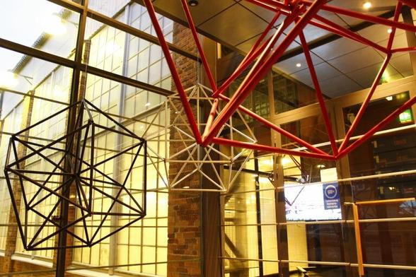 Three grand scale versions of traditional Finnish straw decorations called himmeli, this time made with recycled water pipes