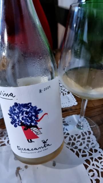 Bottle of 2021 Nina next to a glass of the wine