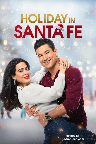 Emeraude Toubia and Mario Lopez embrace in the snow on the poster for Holiday in Santa Fe